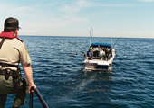 Ontario Provincial Conservation Officer Observing Recreational Vessel